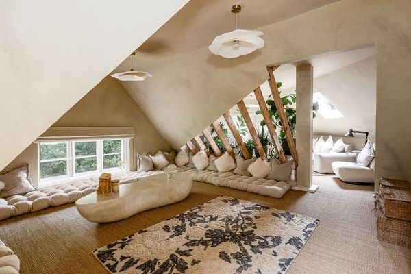 Contemporary attic lounge with exposed timber staircase and natural textures at Love Locations, Liss, Hampshire GU33.