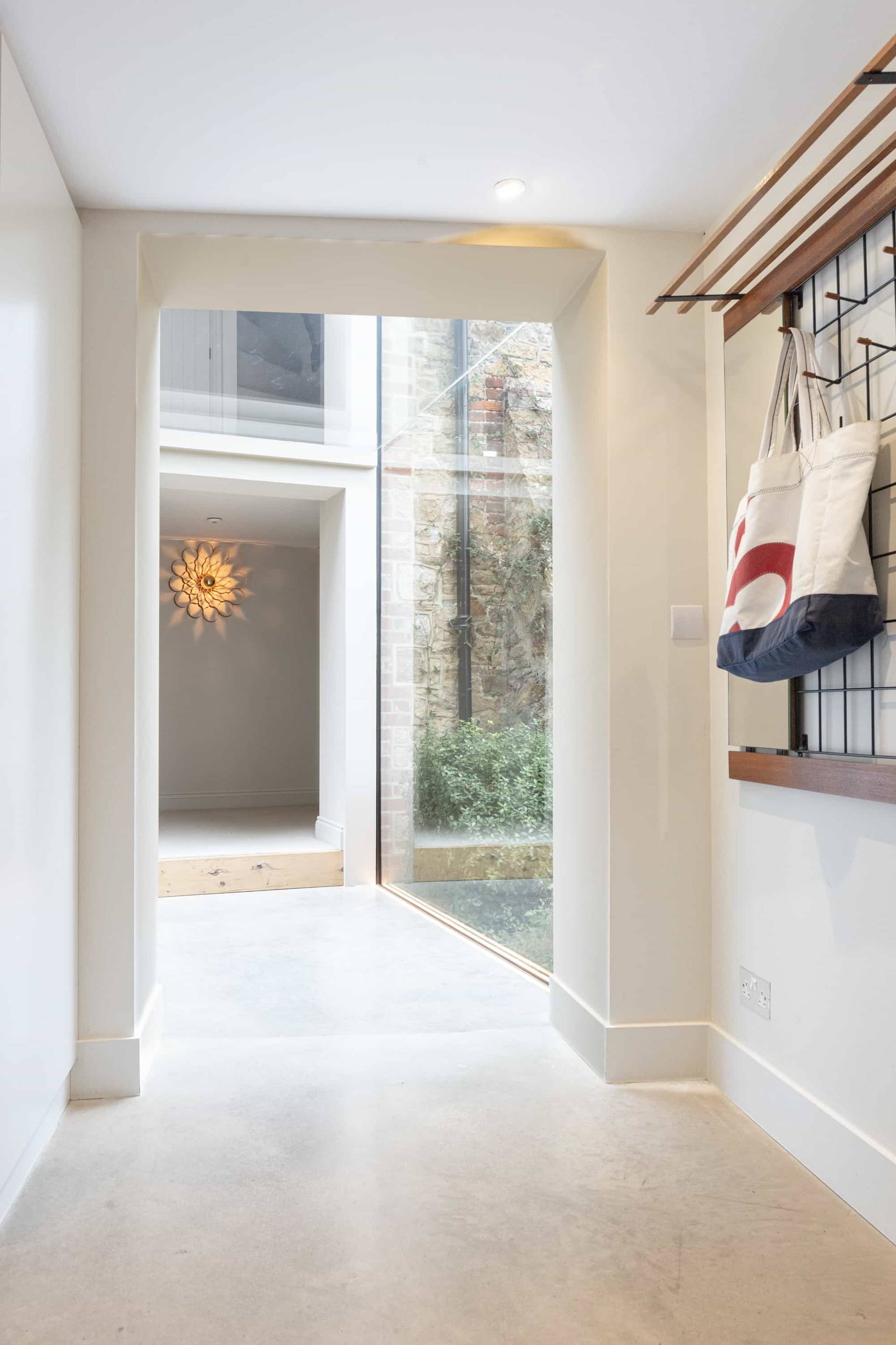 Architectural glass link walkway connecting traditional stone barn structures in West Sussex, Love Locations GU28.