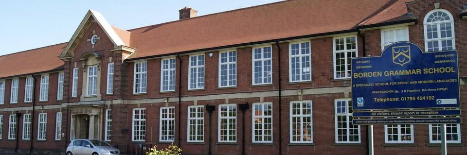 Exterior facade view of a traditional red-brick grammar school building with multi-pane sash windows in Sittingbourne Kent through Love Locations.