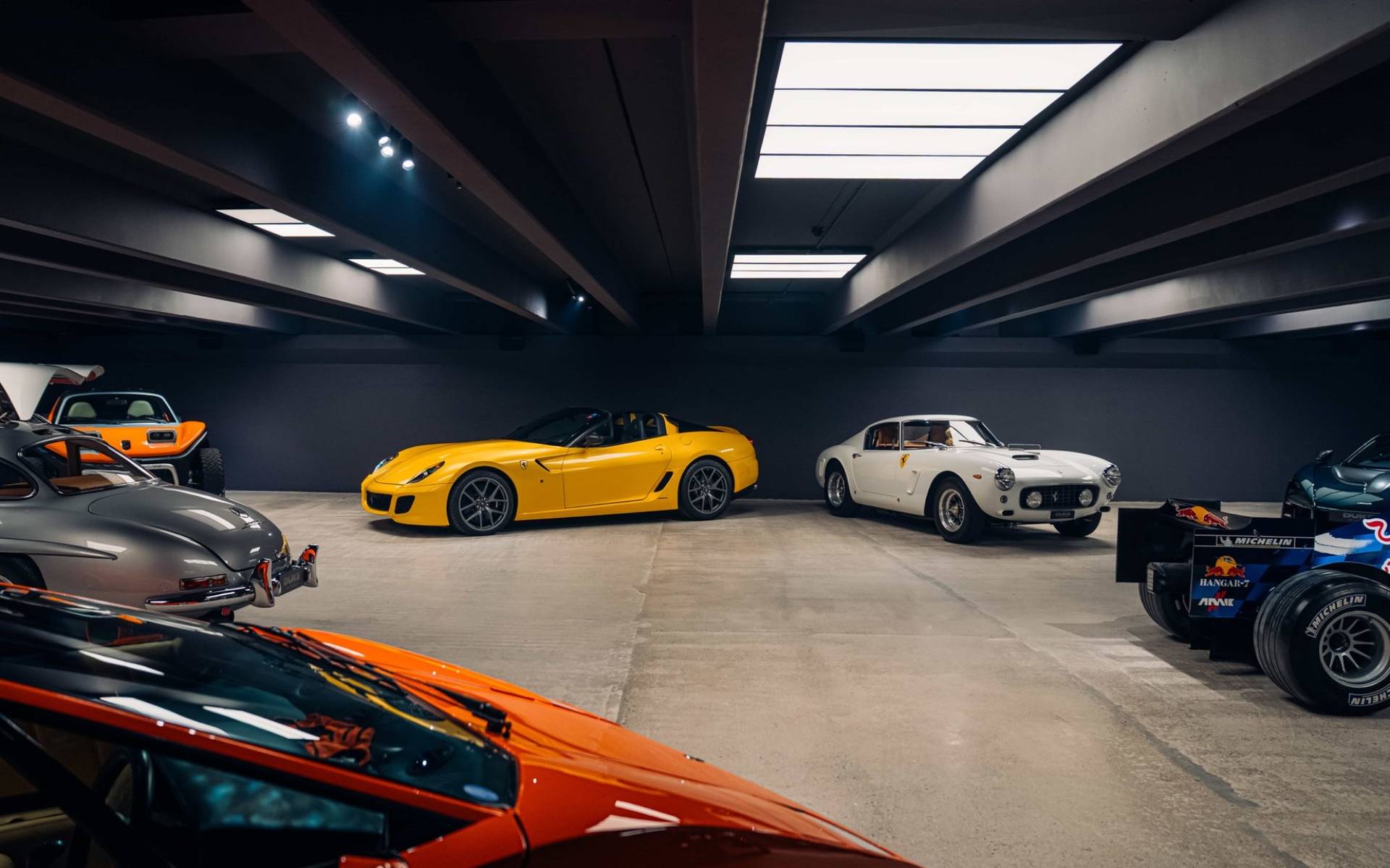 Two rare sports cars parked on polished concrete inside an underground bunker venue in Brentford TW8 by Love Locations.