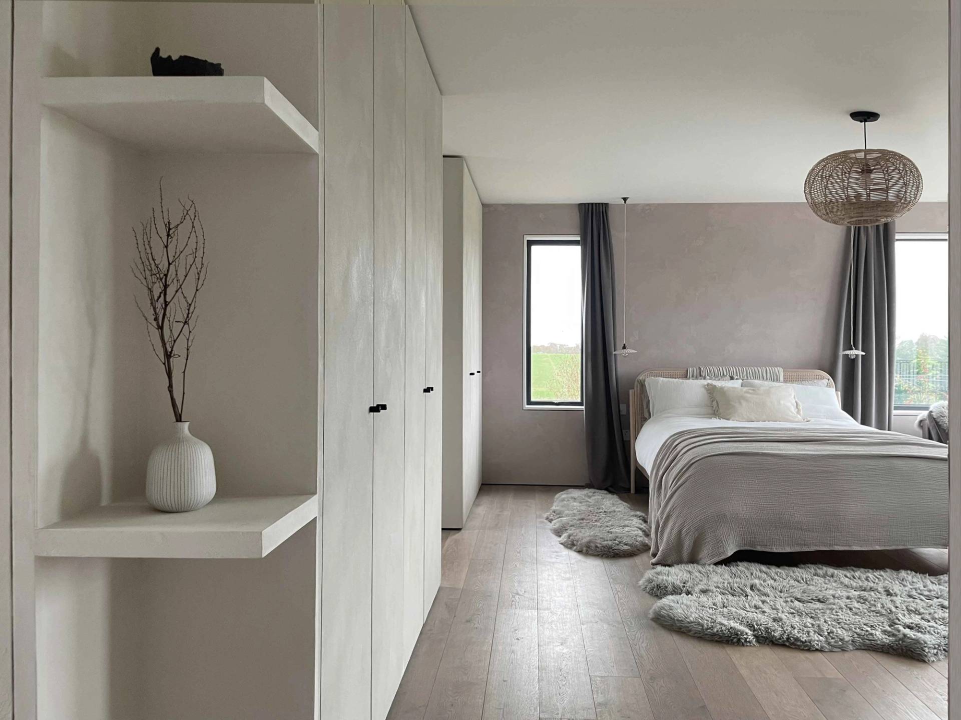 Master bedroom wardrobe dressing area with bespoke plaster wall finishes and built-in storage, Love Locations PO18.