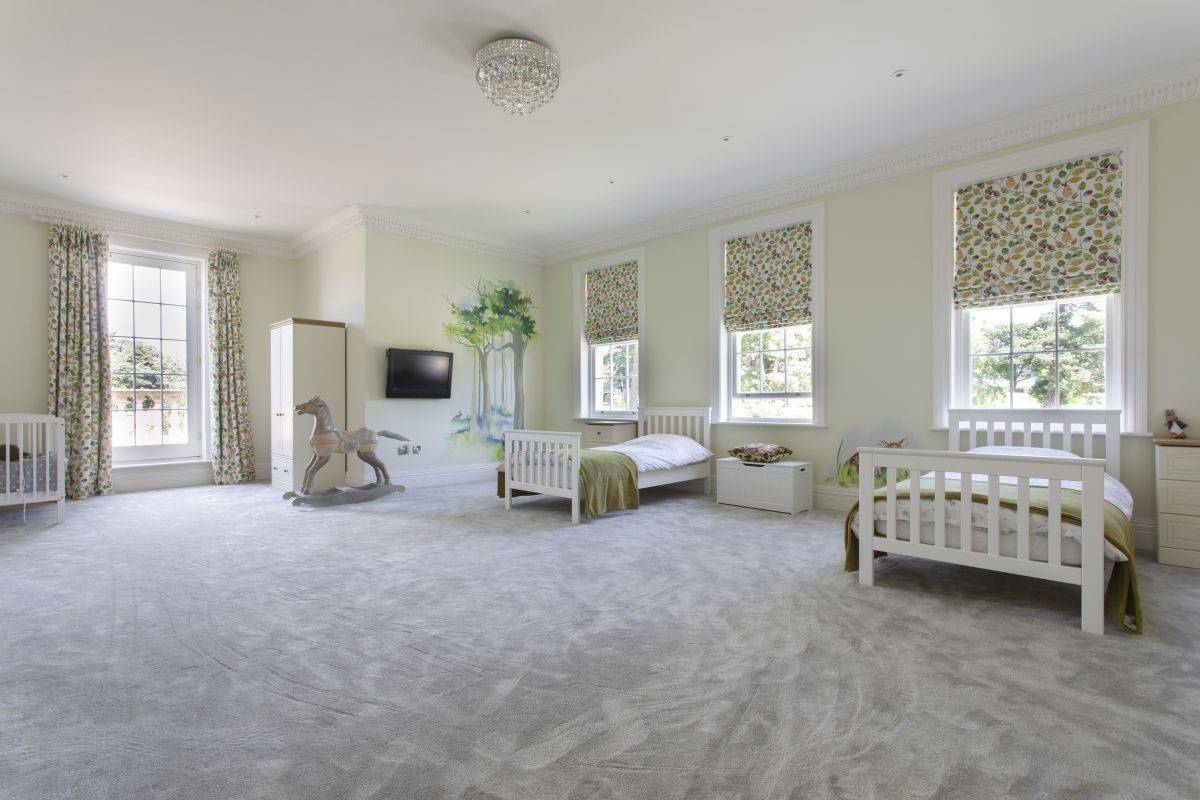 Expansive kids' bedroom featuring a forest mural wall and ample natural light for video productions, listed by Love Locations, RH17.