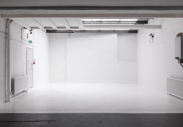 Wide shot of industrial photography studio at Brixton Warehouse Love Locations with exposed brick and high ceilings. 
