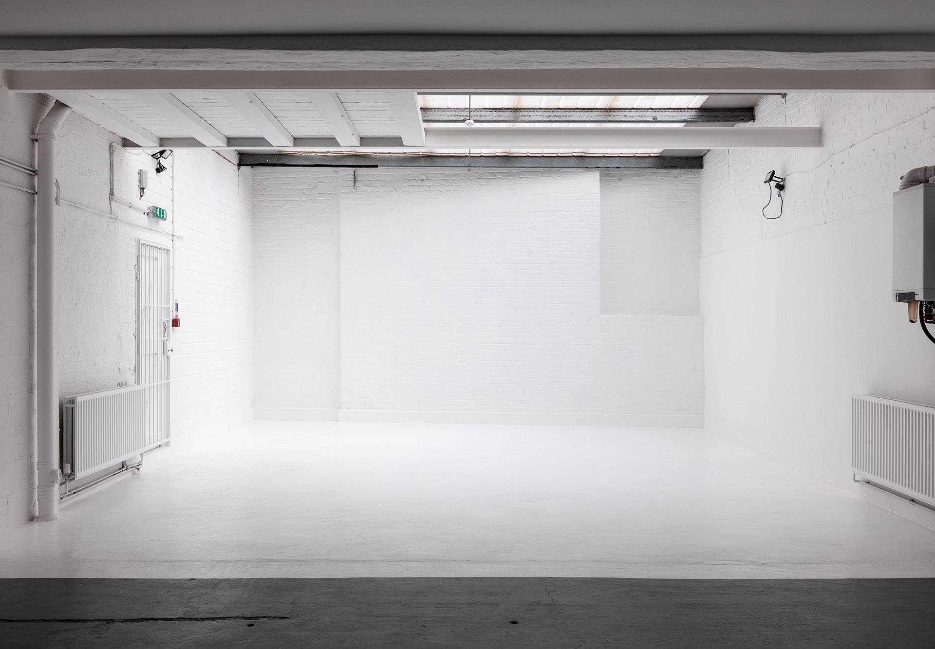 Wide shot of industrial photography studio at Brixton Warehouse Love Locations with exposed brick and high ceilings. 