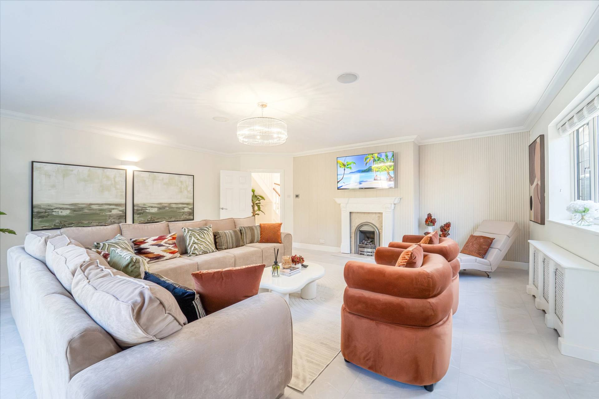 Spacious lounge room styled with plush velvet seating, area rug, and neutral wall tones, Love Locations RM11.