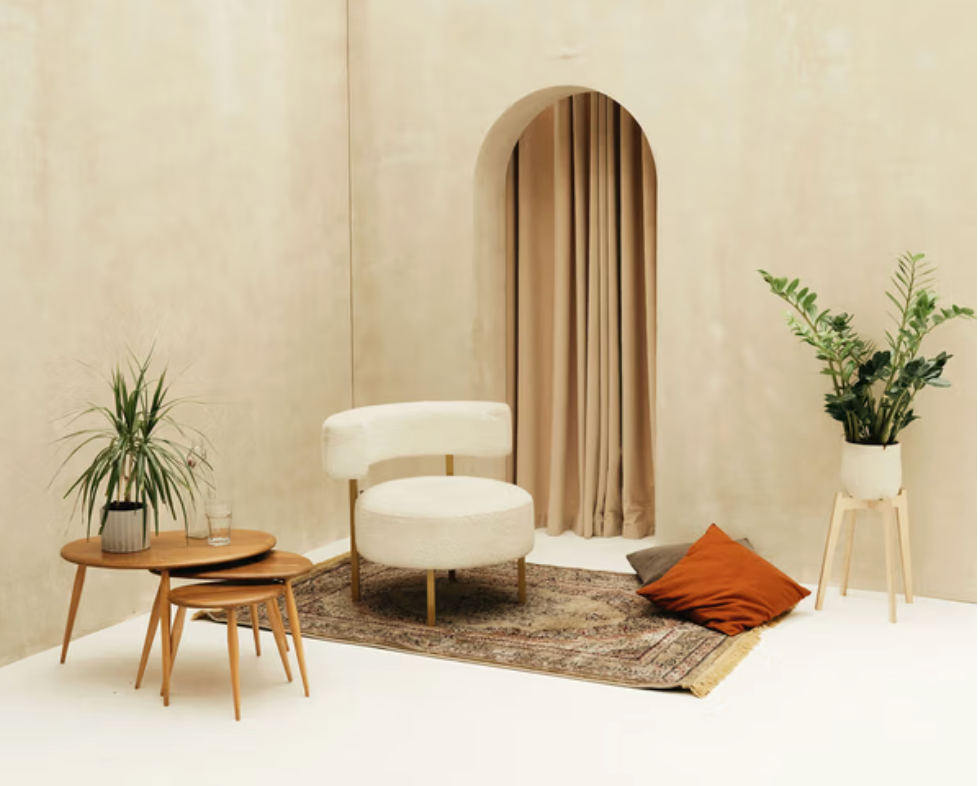 Minimalist lounge area with armchair and plants at Brixton Warehouse, perfect for Christmas event breakout spaces.