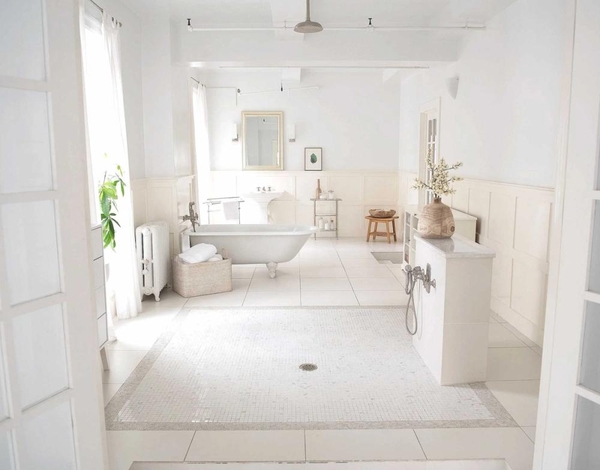 Spacious luxury loft bathroom featuring a freestanding clawfoot bathtub and mosaic tiled floors, the ultimate backdrop for beauty and wellness brand campaigns via Love Locations.