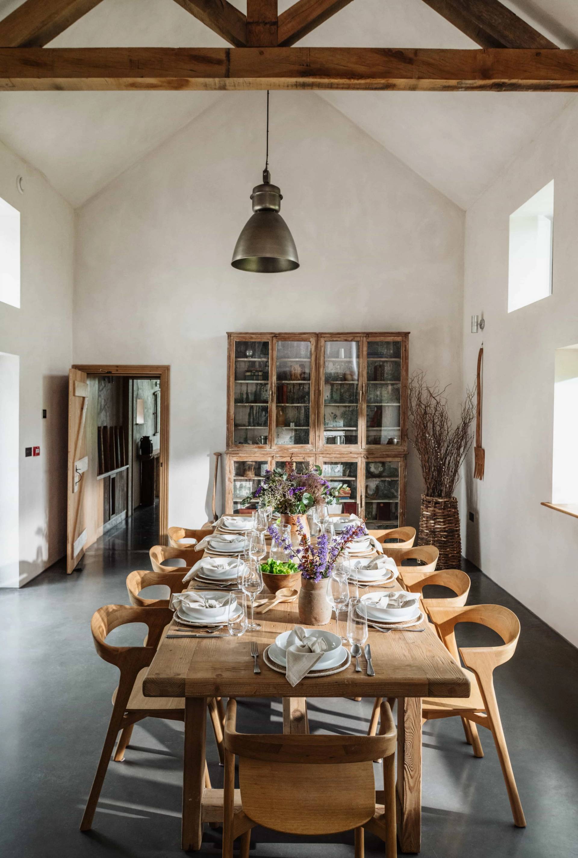 Banquet dining room location house in Castleblayney County Monaghan Ireland via Love Locations, highlighting double-height ceilings, exposed timber framework, and countryside views.