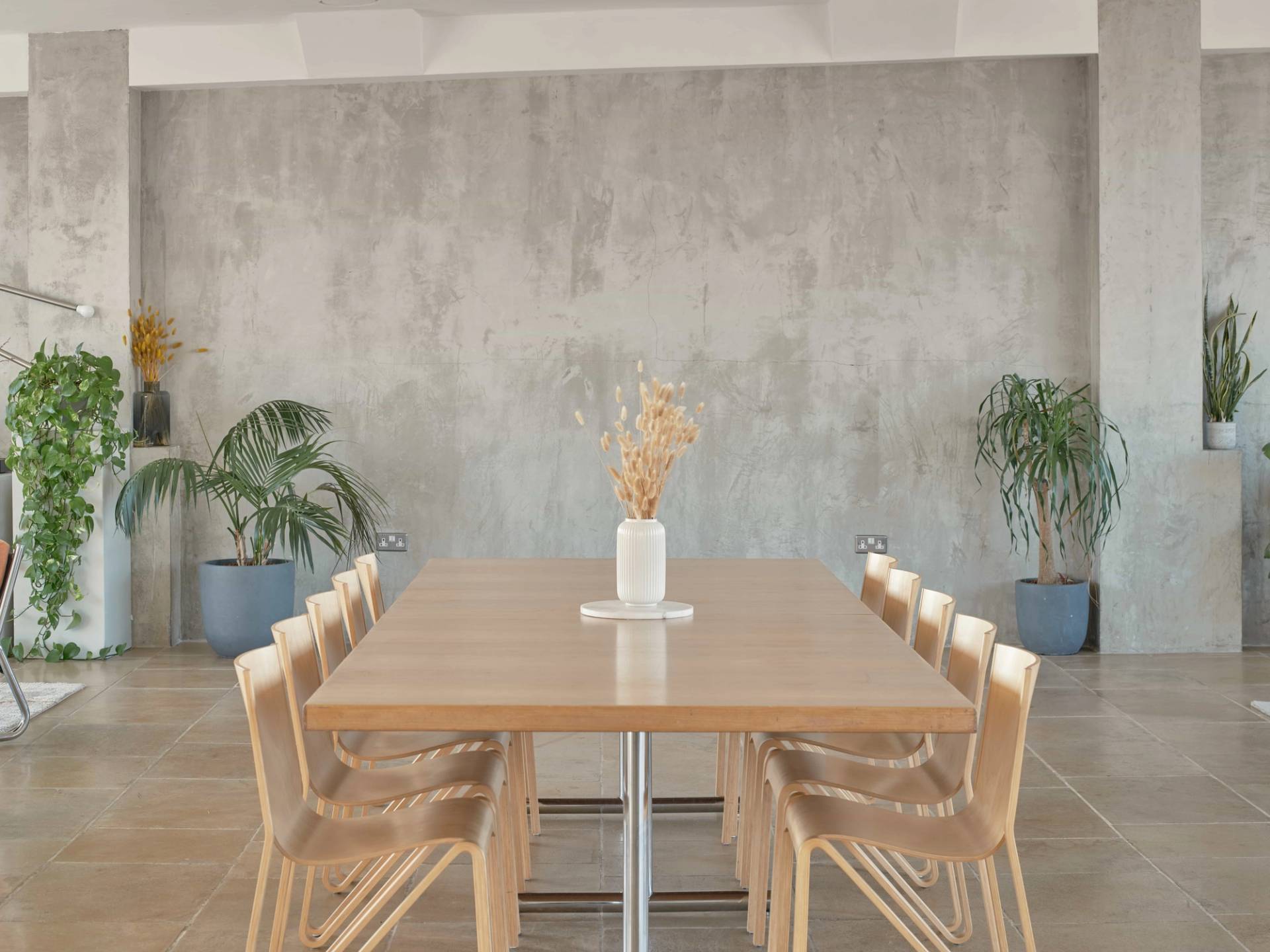Modern dining setup at THE PENTHOUSE SE1 with natural wood and greenery.
