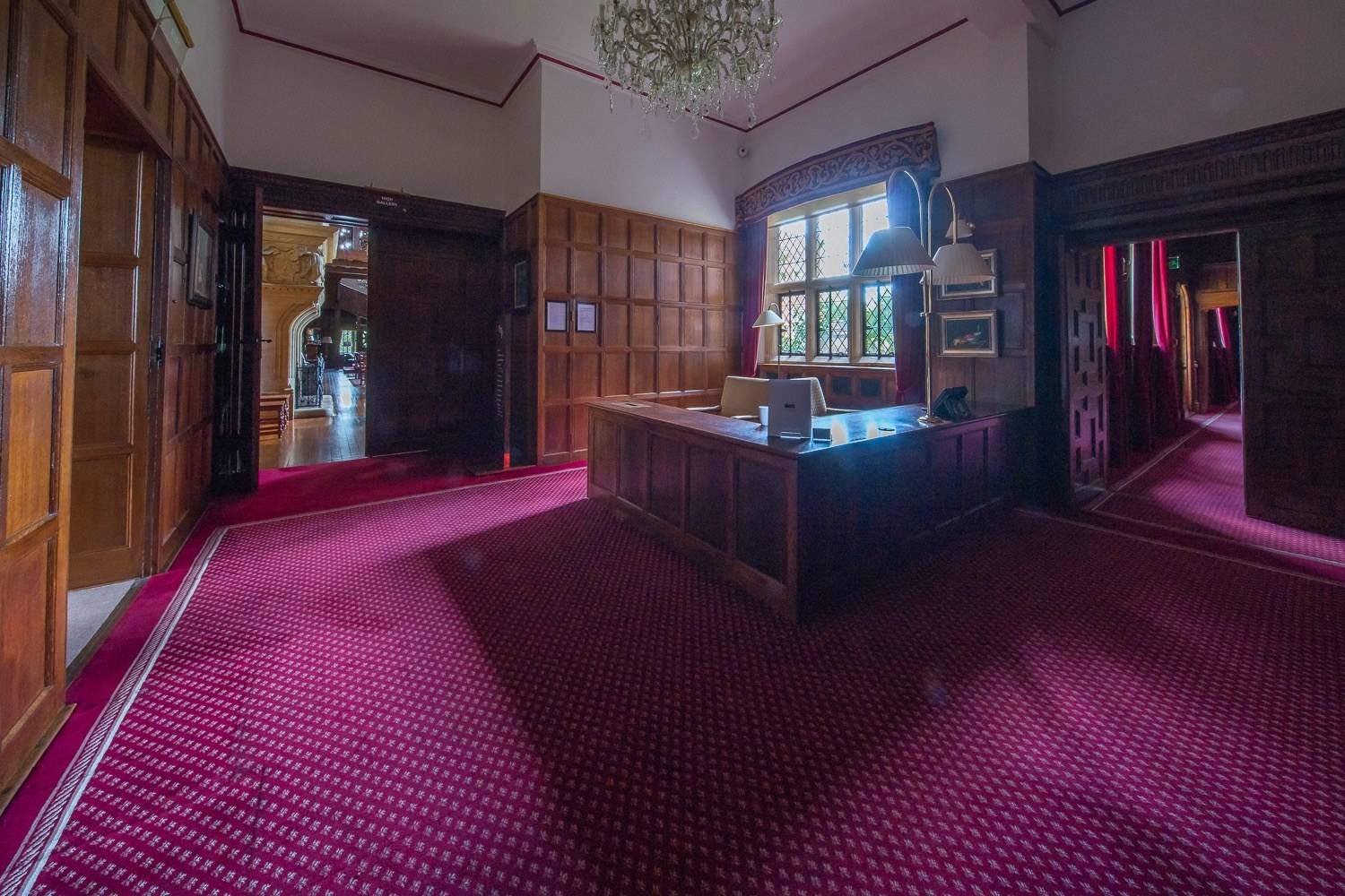 Rich mahogany panelled boardroom and executive study shoot space with magenta carpet and lattice windows through Love Locations.
