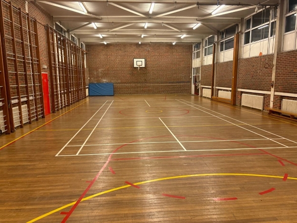 Love Locations traditional school gym shoot location Chelmsford Essex CM1: Classic sports hall featuring wood-panelled walls, wall bars, and a polished floor, great for retro or modern school physical education scenes.