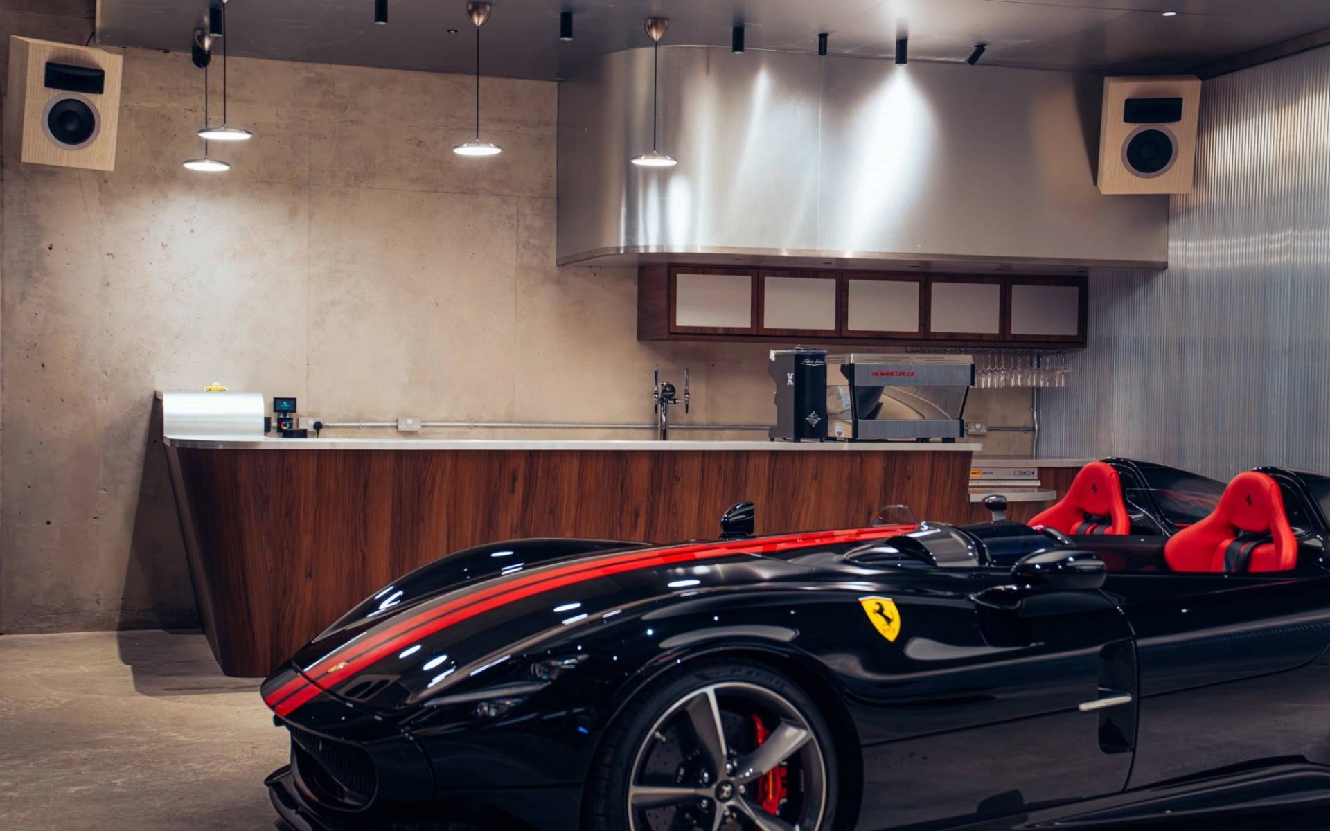 Close-up detail of a black sports car with red racing stripes in a modern venue location house from Love Locations.