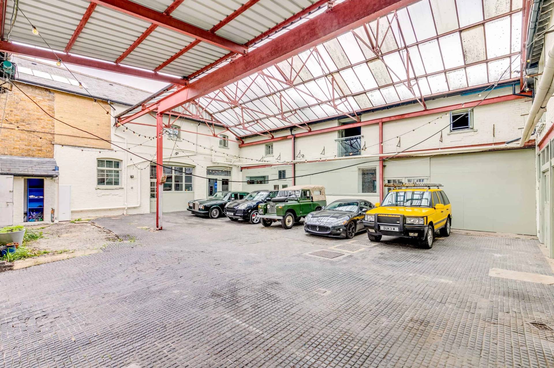 Premium car photography and commercial filming location space with industrial warehouse backdrop, curated by Love Locations.