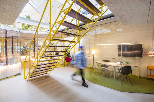 Contemporary London workspace with yellow staircase and collaborative desk areas in Notting Hill W11 – love locations