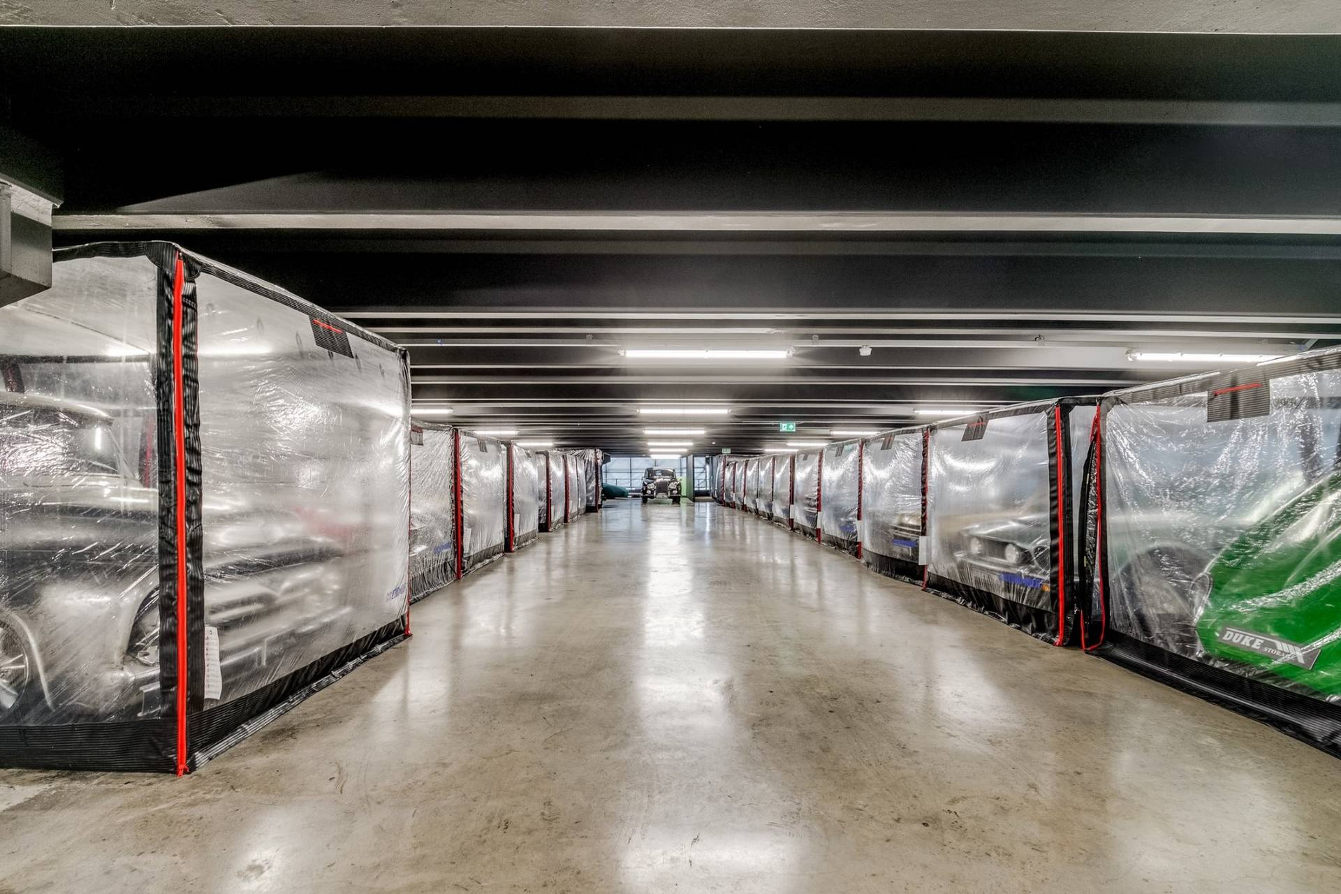 High-ceiling industrial car storage facility for music videos and commercial filming in Brentford TW8 through Love Locations.