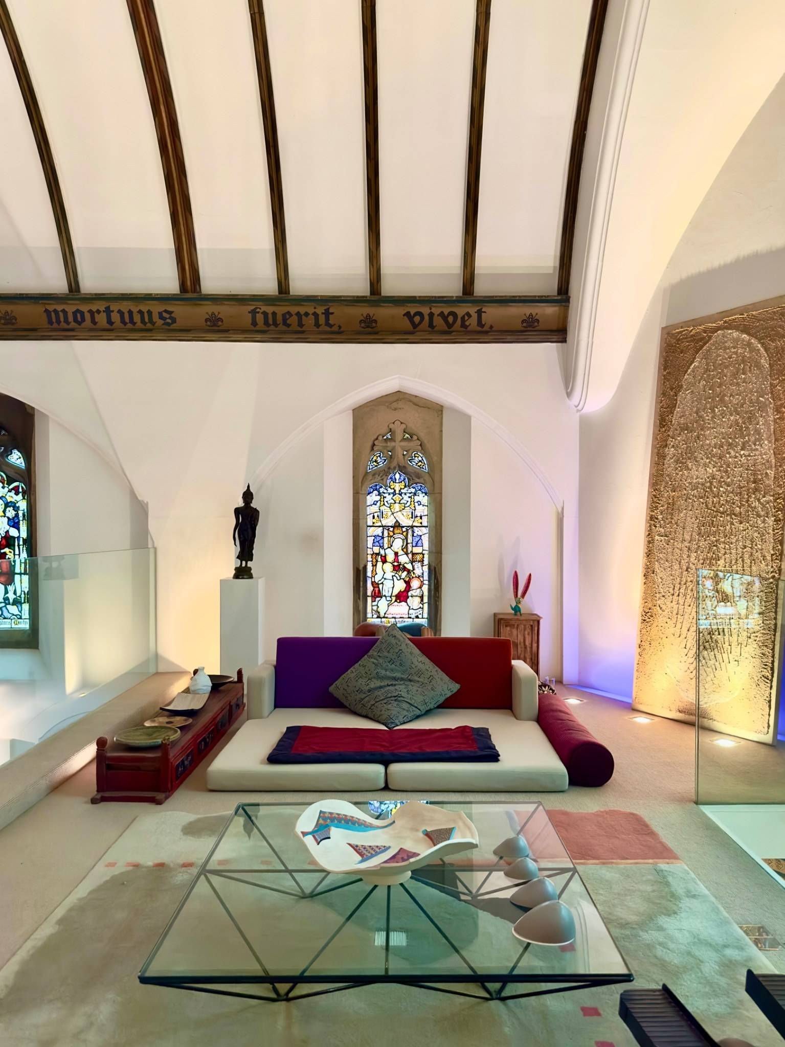 Raised platform bed layout under vaulted whitewashed ceilings in a church conversion shoot location in Oval SE5 through Love Locations.
