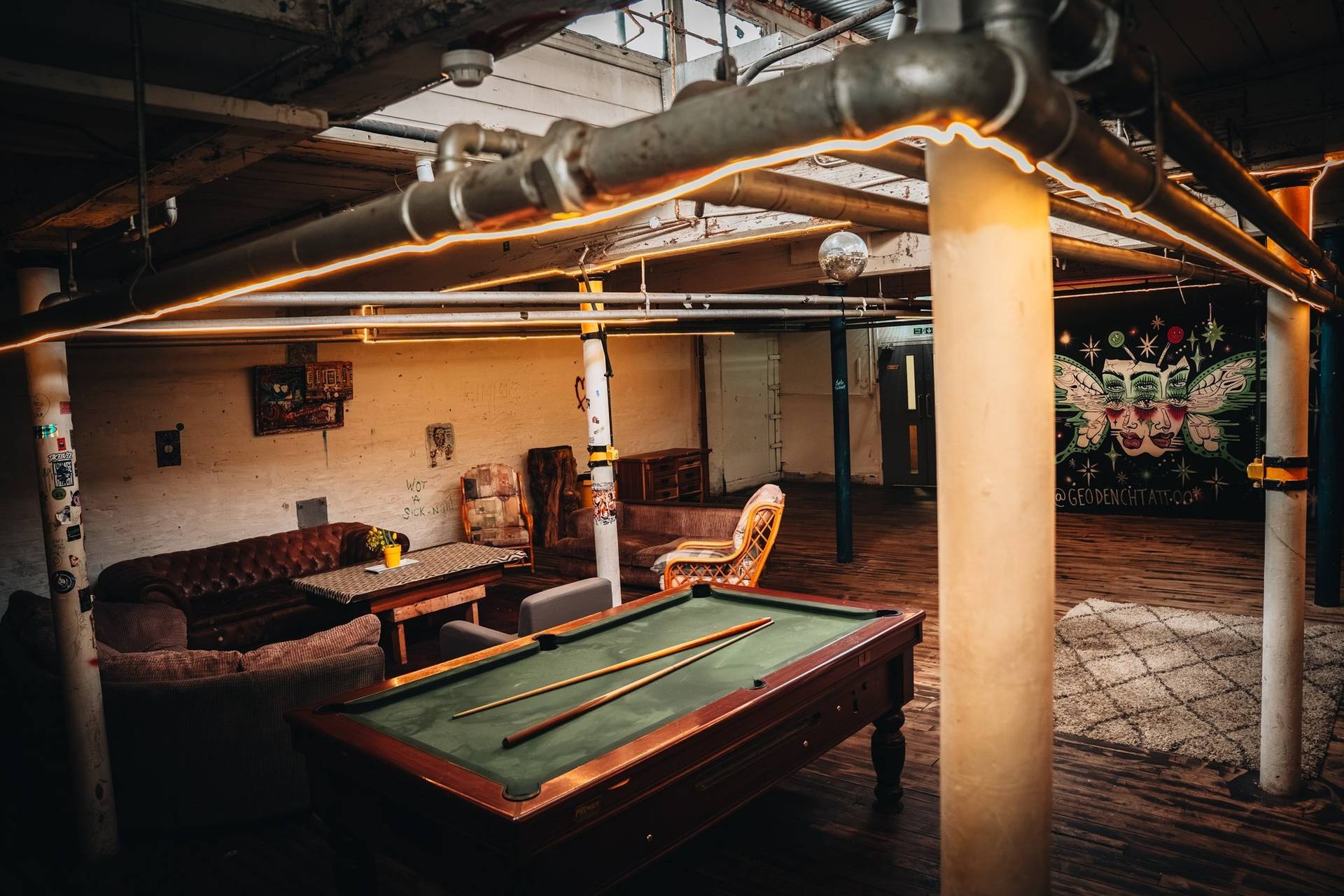 Pool table recreation area and rustic lounge seating in an industrial Manchester M3 shoot location via Love Locations.