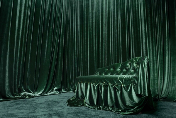 Moody emerald green photography set with draped velvet curtains and a tufted velvet couch in Tottenham, Love Locations N15.