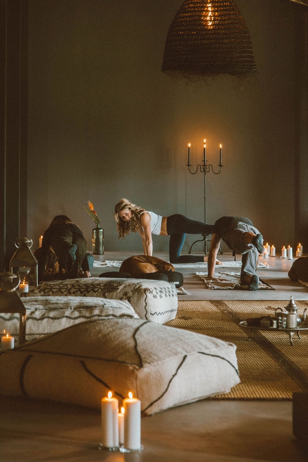 Private wellness yoga studio with floor mats, candle lighting, and warm moody wall tones, Love Locations 07630.