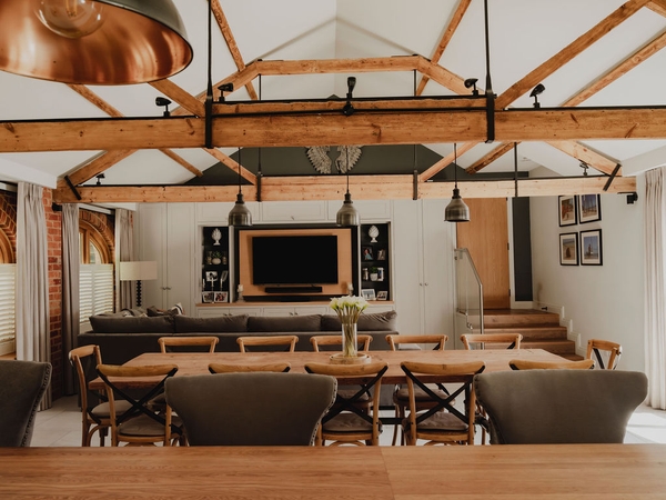 Wide view from the kitchen across a grand open-plan barn dining area and lounge setup, perfect for TV drama filming base setups, Love Locations RG9.