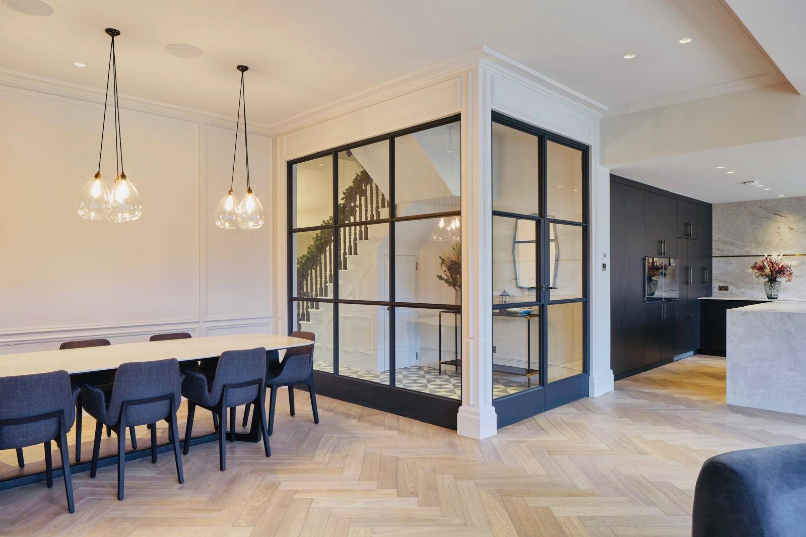 Black steel Crittall glass room divider wall separating the dining space from the hallway, Love Locations TW11.