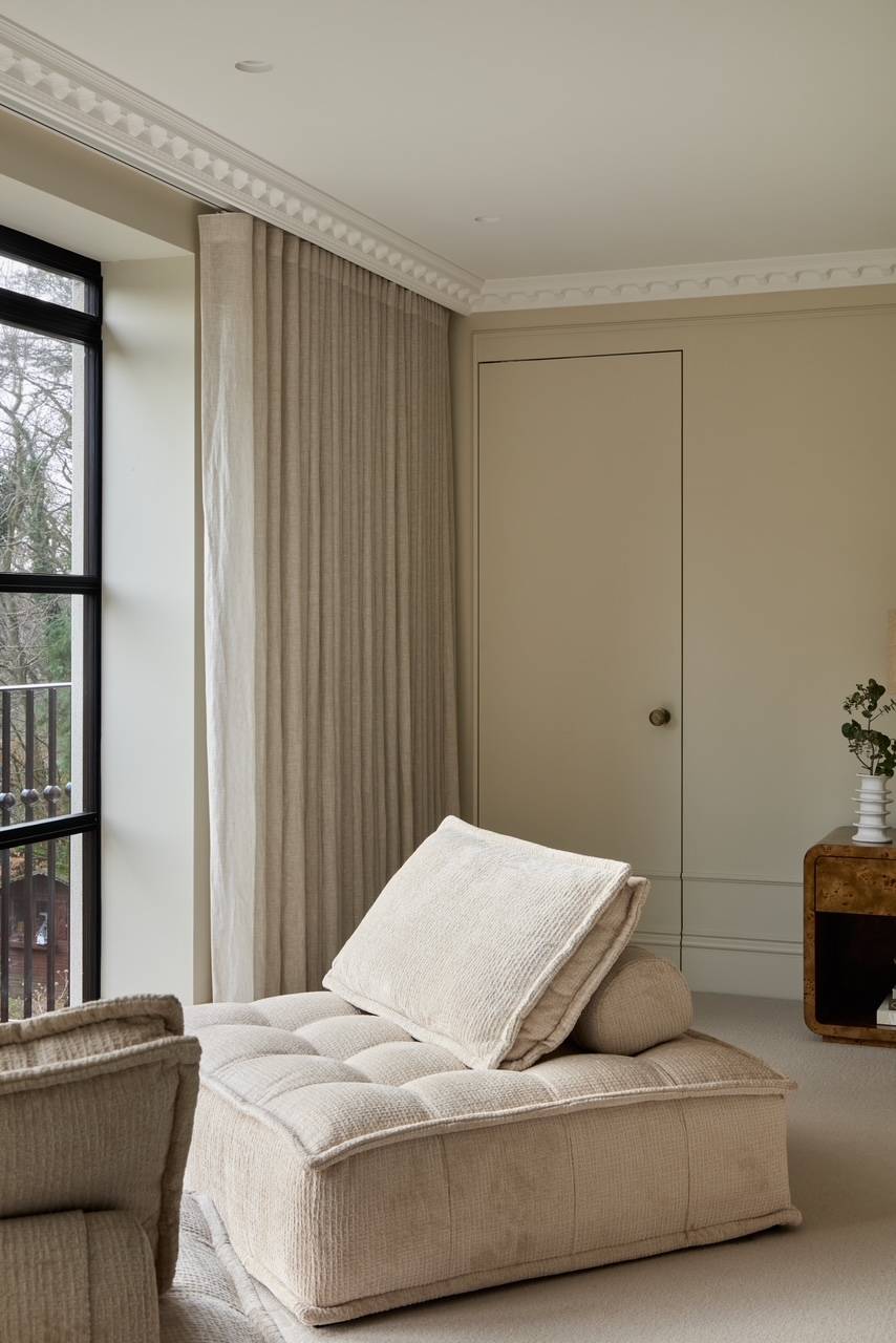 Sunlit bedroom corner featuring a luxury upholstered daybed alongside floor-to-ceiling sheer drapery, ideal for high-end loungewear brand campaigns, Love Locations WD23.