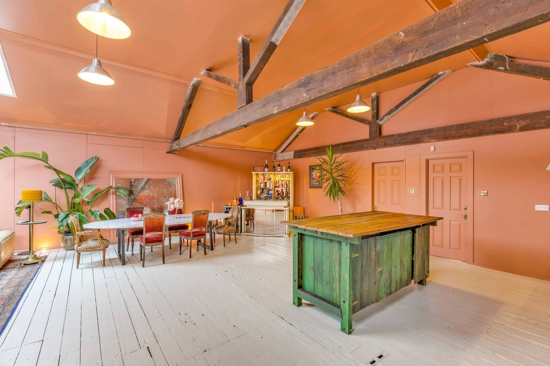 Rustic kitchen shoot location with a distressed green island and stainless steel countertops, listed by Love Locations.