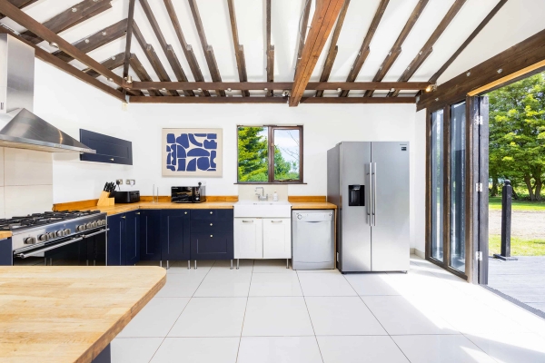 Converted barn interior with exposed beams in RM4 Essex – Love Locations