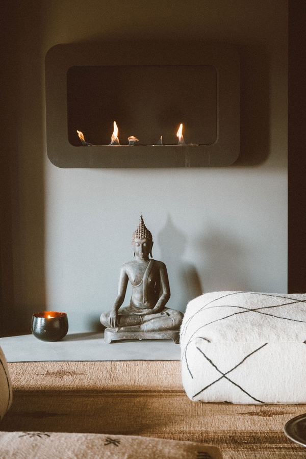Wellness spa room featuring a massage treatment table, Buddha statue, and ambient wall lighting, Love Locations 07630.