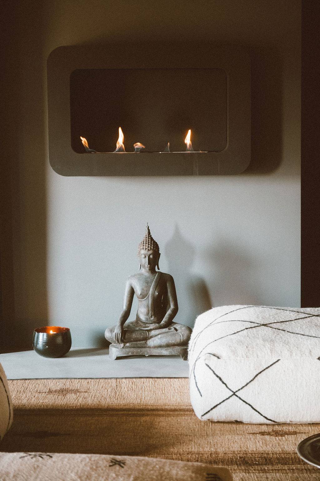 Wellness spa room featuring a massage treatment table, Buddha statue, and ambient wall lighting, Love Locations 07630.