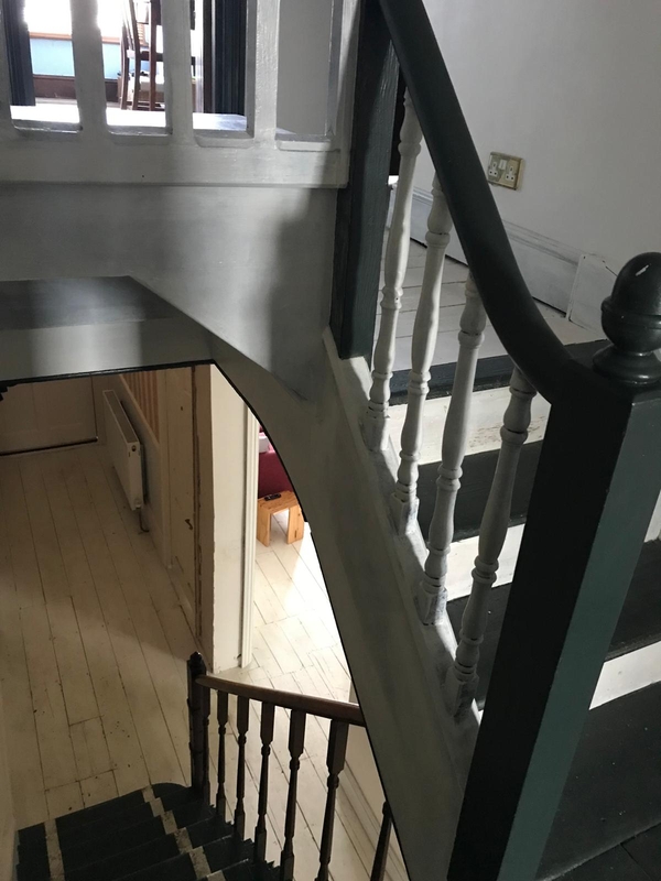 High-angle perspective looking down a vintage wooden stairwell structure inside a character property in Croydon, suitable for creative perspective filming, Love Locations.
