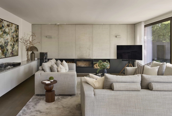 Minimalist lounge location space featuring polished concrete wall finishes and contemporary furniture, listed by Love Locations.