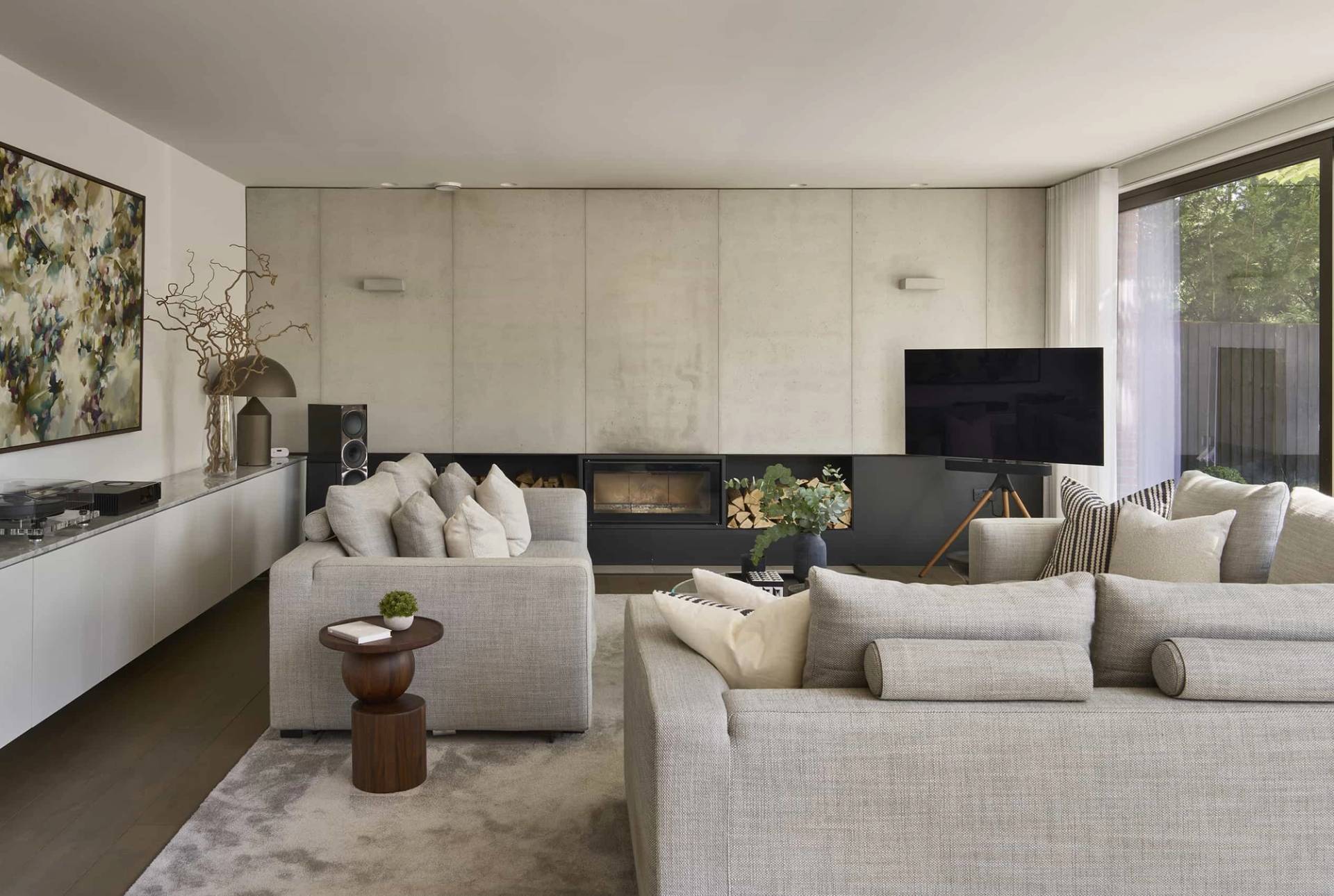 Minimalist lounge location space featuring polished concrete wall finishes and contemporary furniture, listed by Love Locations.