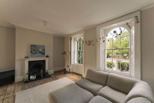 Contemporary grey sectional sofa set up in a bright, high-ceilinged reception room in South London, SW9, perfect for interior design lookbooks, Love Locations.