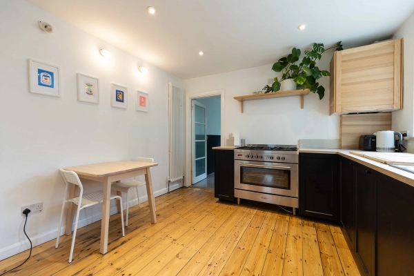 Love Locations residential kitchen location East London: Bright open-plan kitchen space showing natural wood pine floors and minimalist styling, perfect for domestic scenes in TV series and brand ads.