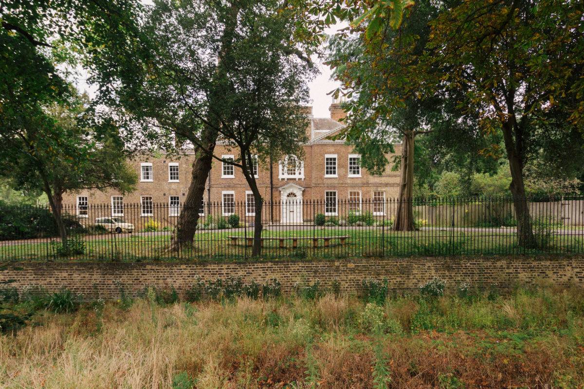 Lush green estate lawns looking towards a grand Georgian brick manor house, ideal for outdoor event setups, Love Locations SE15.