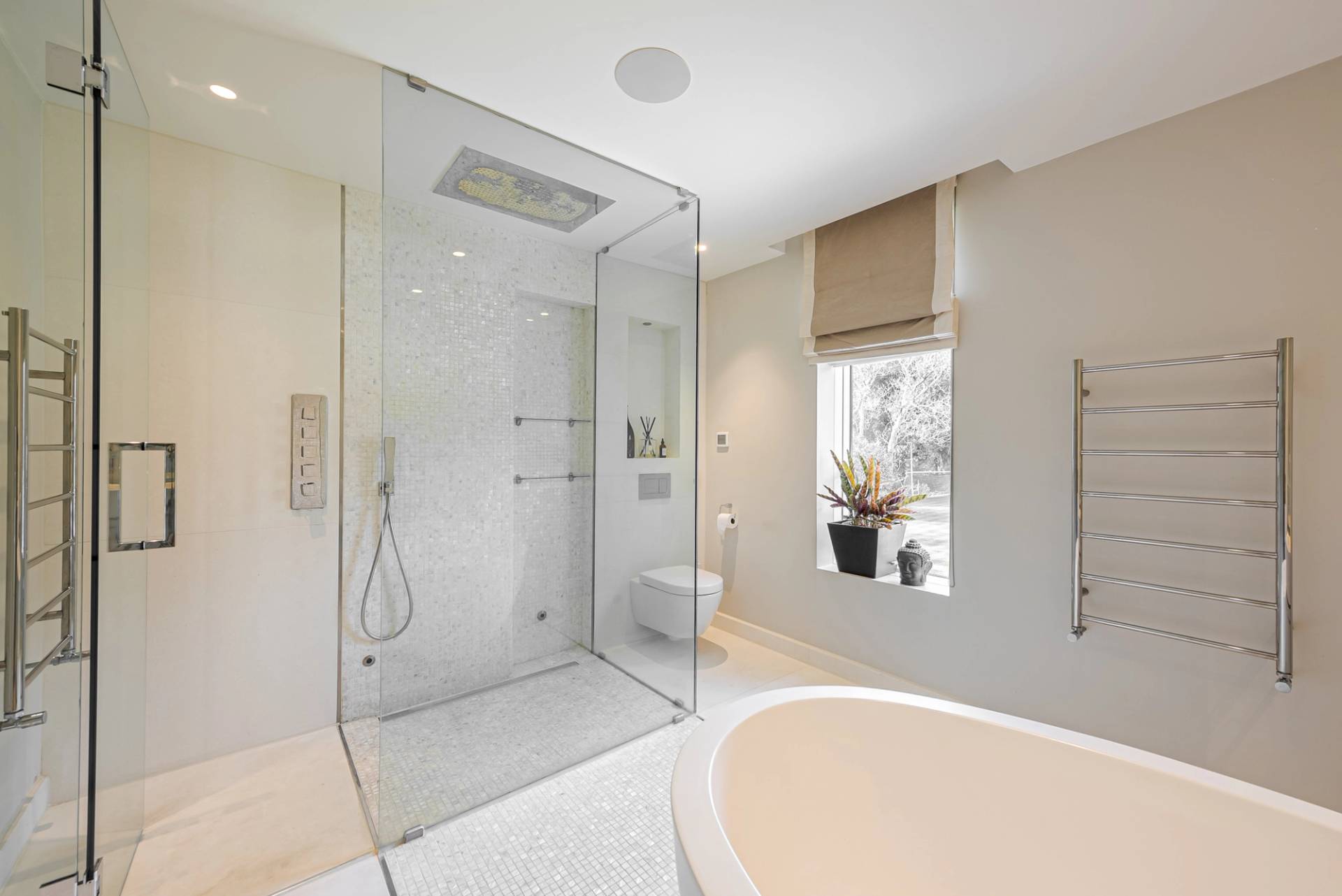 Luxury master ensuite bathroom featuring a wet-room rainfall shower, freestanding tub, and chrome fixtures, Love Locations KT2.