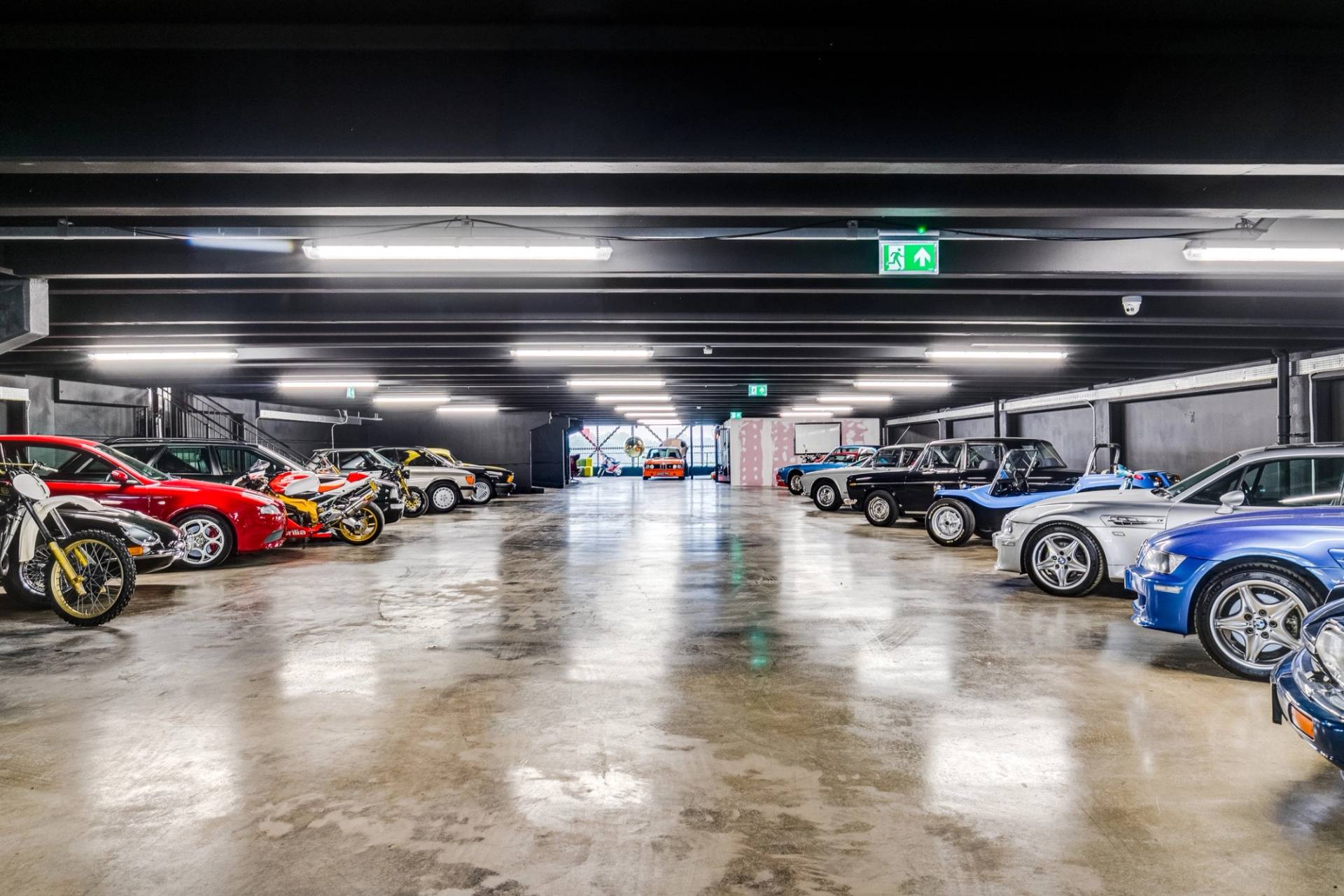 Spacious car showroom floor filled with classic cars for film and photography in West London via Love Locations.
