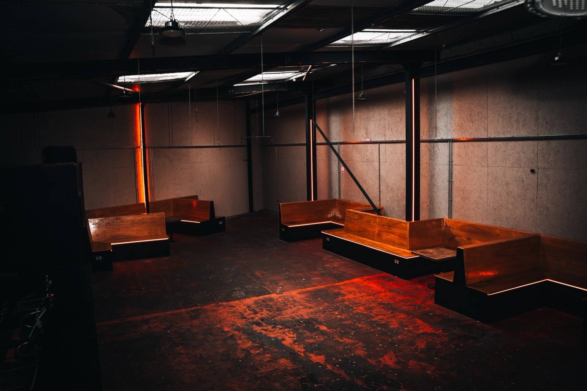 Spacious warehouse hall shoot space with long bench seating and overhead natural roof lighting in Manchester M3 by Love Locations.