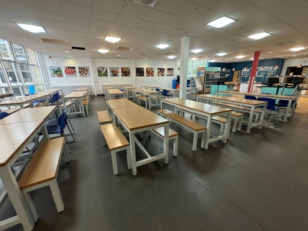 Love Locations versatile school dining hall Cockfosters: Close tracking perspective across wooden picnic-style cafeteria tables, excellent for television dramas and commercial video production.