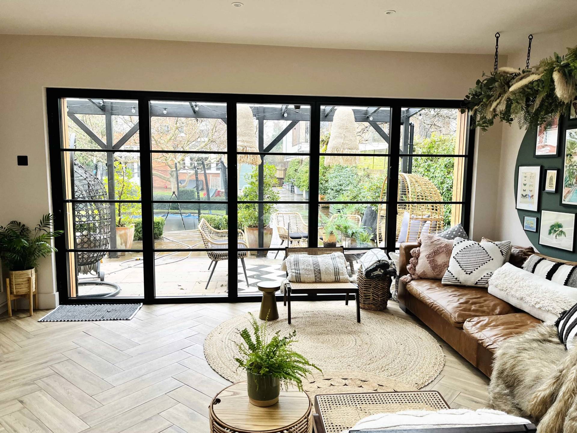 Garden room extension with full-height black crittall folding patio doors and parquet flooring, Love Locations TW11.