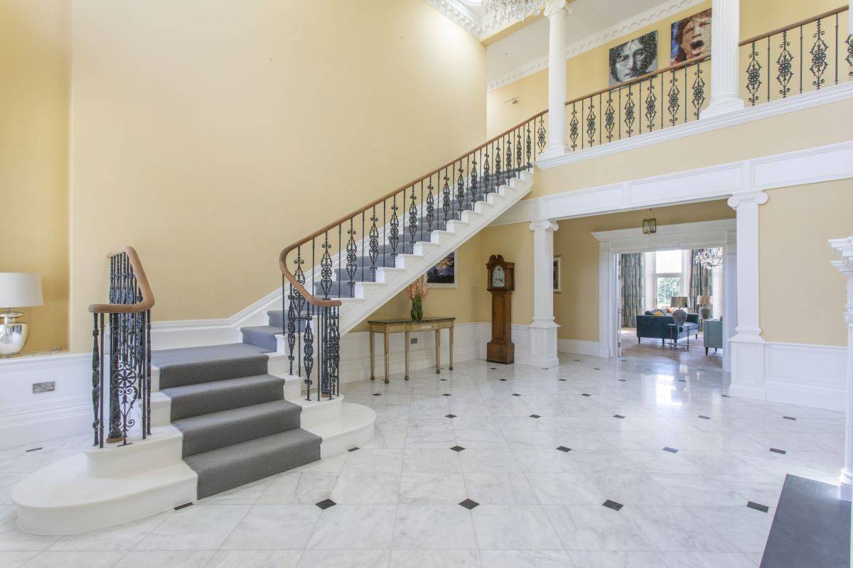 Stunning grand imperial staircase with decorative iron railings and marble floors for film and TV shoots, listed by Love Locations, West Sussex.