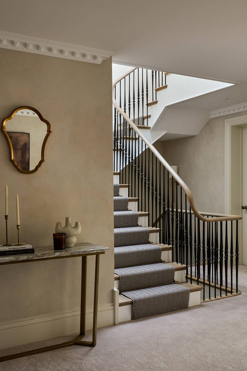 Hallway console table styling featuring an antique arched wall mirror and warm neutral plaster textures in Hertfordshire, perfect for decor brand catalogs, Love Locations.