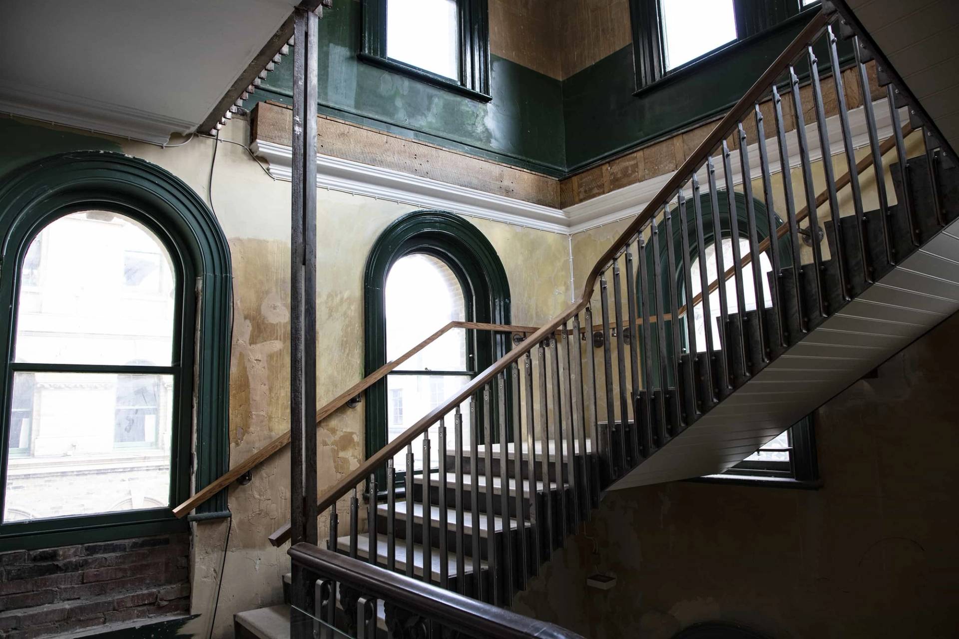 Weathered brick staircase in a derelict Peckham Rye billiards hall, part of the Love Locations Old Waiting Room venue for film shoots, pop-up exhibitions, and unique private events.