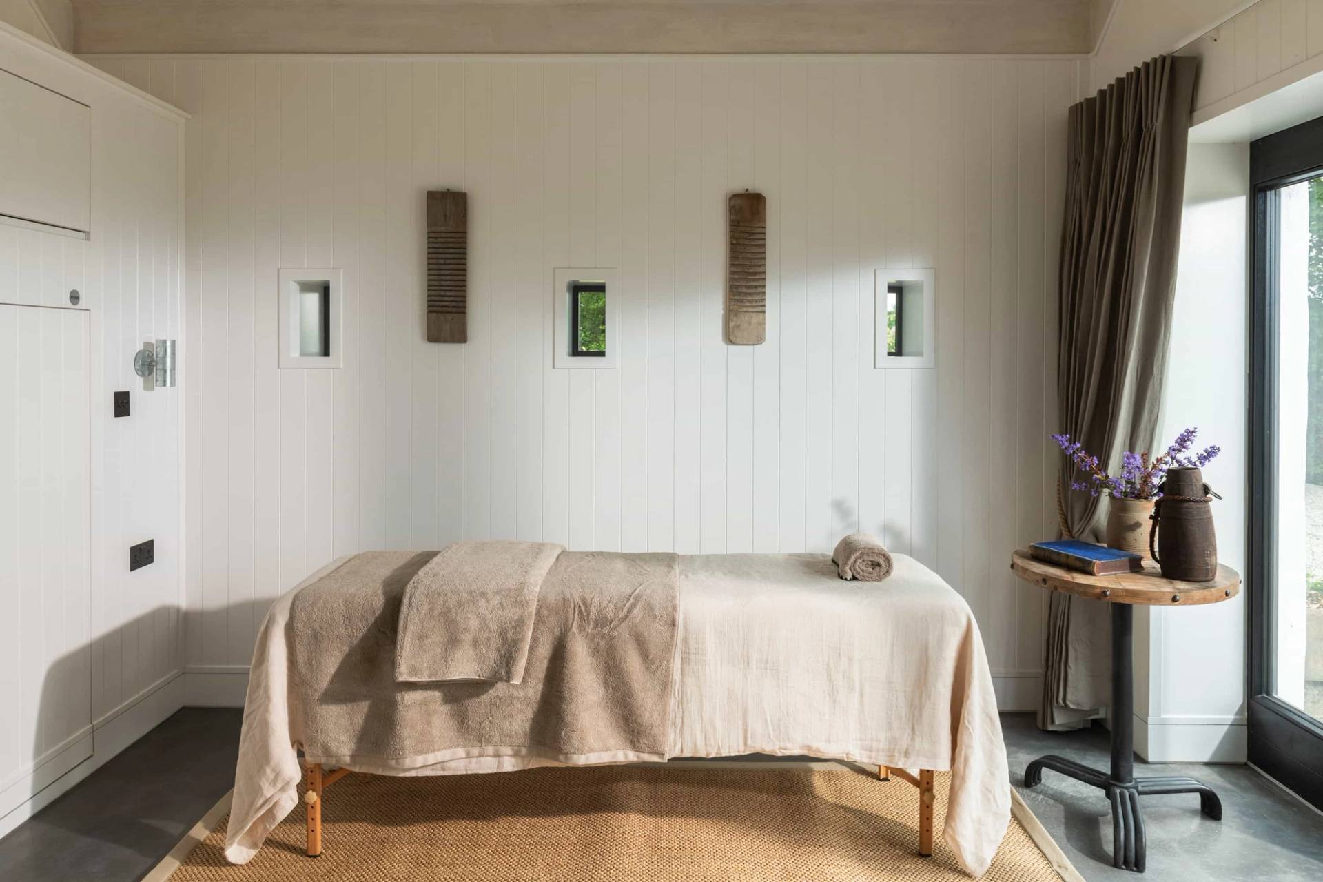 Private massage or treatment room location house in Castleblayney County Monaghan Ireland from Love Locations, featuring a treatment table and minimalist decor.