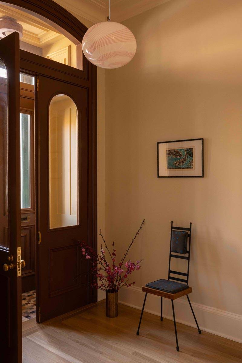 Classic 19th-century townhouse entryway and foyer film location in Boerum Hill Brooklyn NY 11217 via Love Locations, with dark wood double front doors, transom glass, and light warm walls.