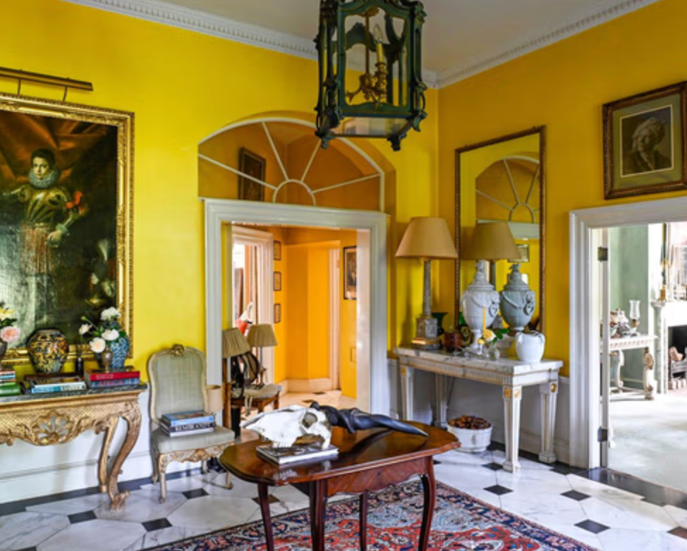 Grand entrance hall at Greengate with butter-yellow walls, marble flooring and beautifully preserved period features.