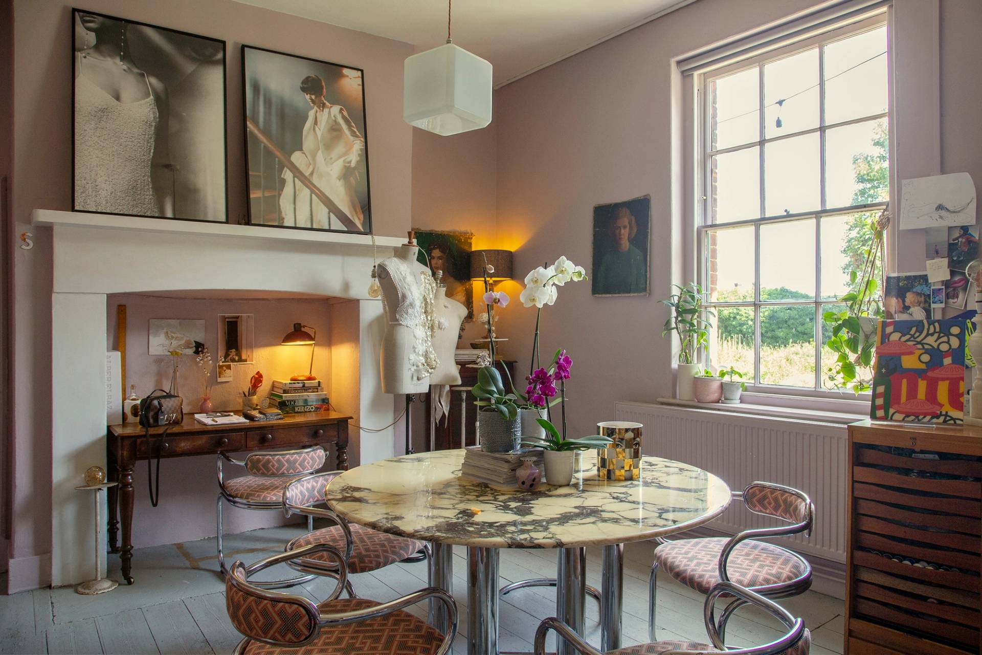 Eclectic study room featuring a round wooden dining table, period fireplace hearth, and sash windows, Love Locations ME13.