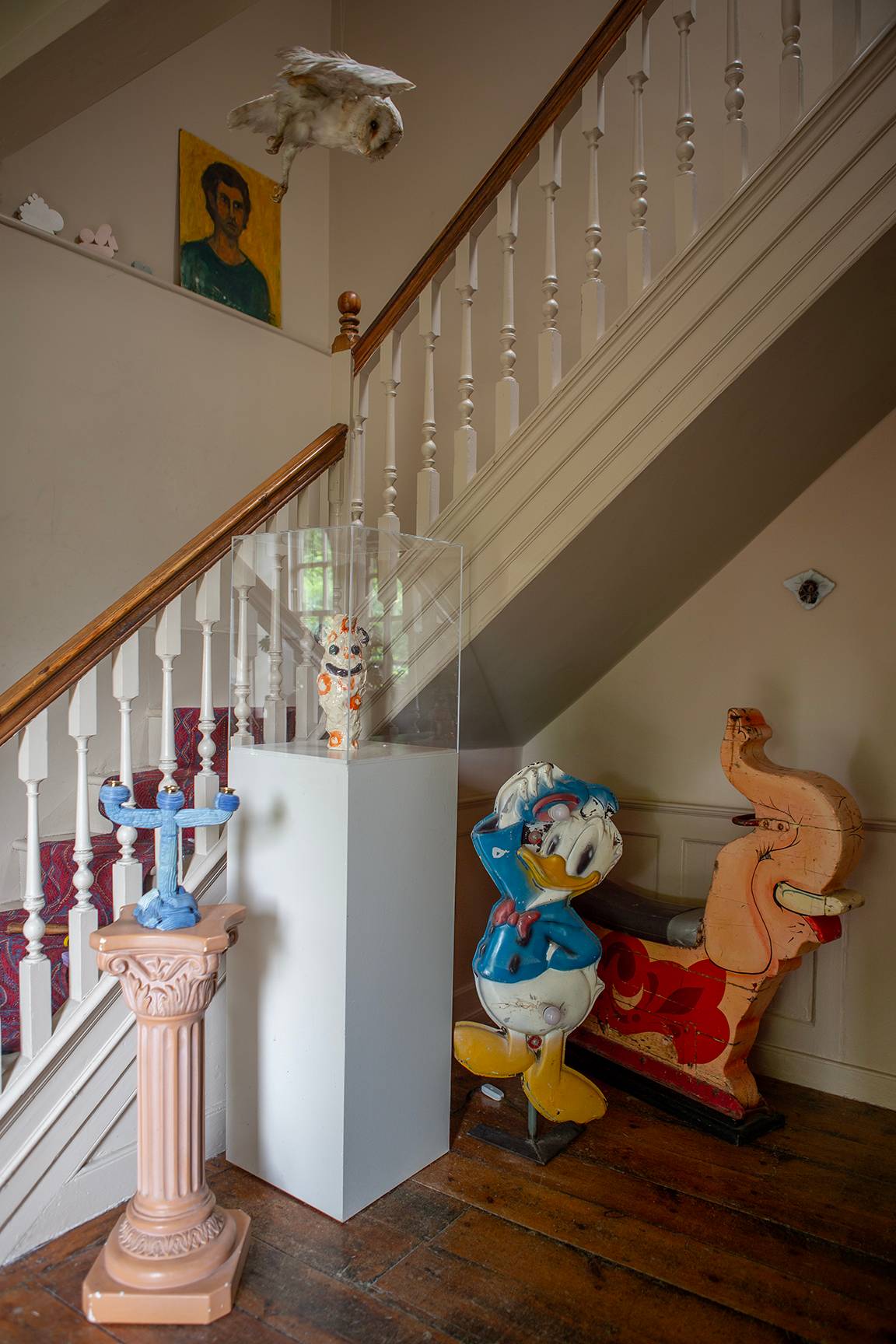 Period staircase balustrade featuring a novelty Donald Duck statue and decorative sculptures, Love Locations ME13.