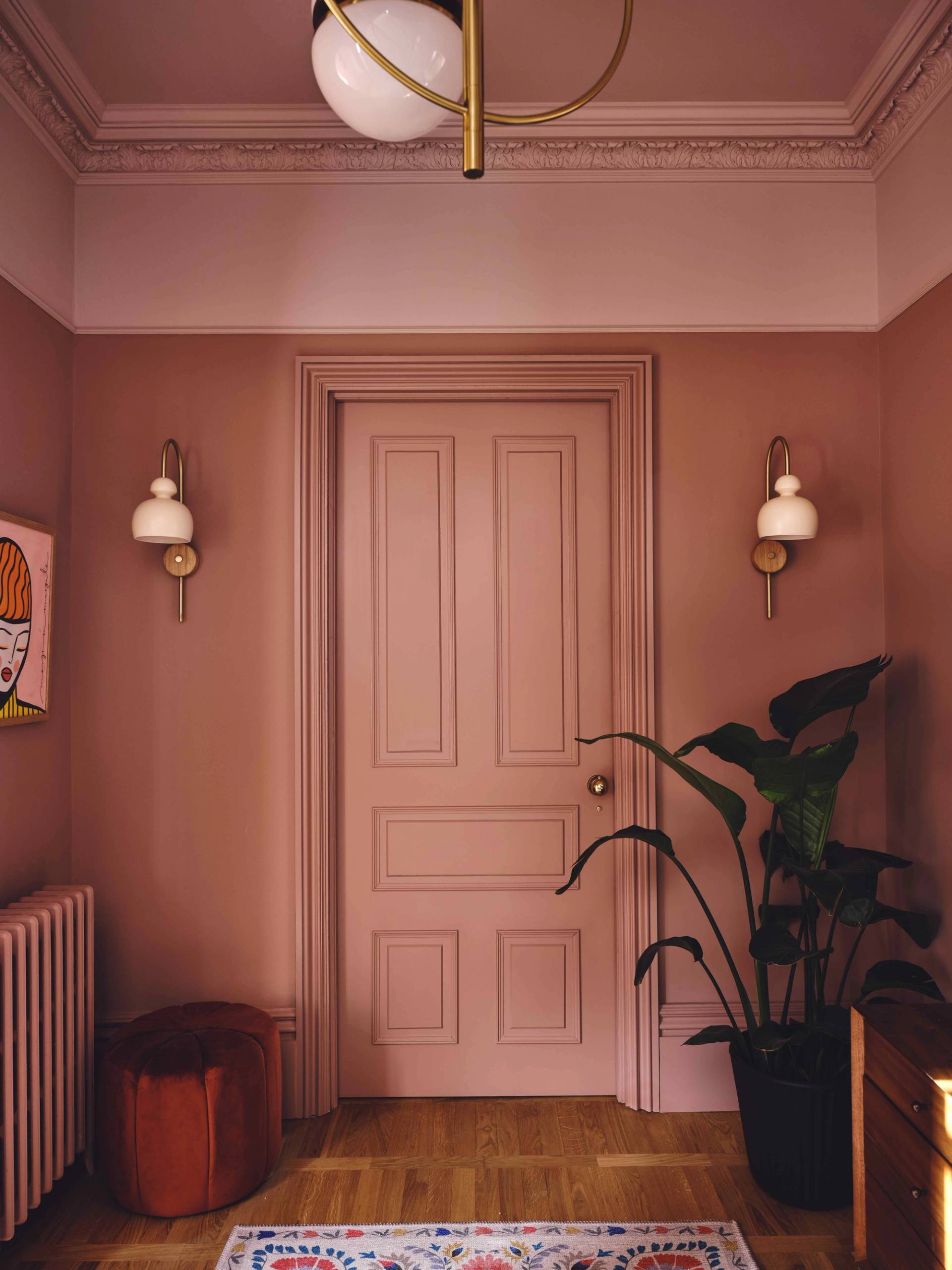 Plaster pink doorway flanked by twin vintage brass wall sconce lamps, Love Locations CR0.